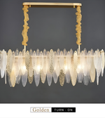 Decorative chandelier with gold and glass elements on a dark background