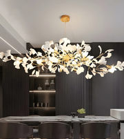 Modern chandelier with white floral design in a dining room setting.
