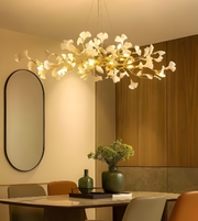 Modern chandelier in a dining room setting with a table and chairs.