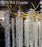 Chandelier with crystal pendants and gold accents, labeled '100% K9 Crystal'.