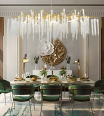 Elegant dining room with a large chandelier, table set for dinner, and decorative wall art.