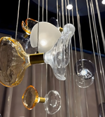 Close-up of a modern chandelier with glass and metal elements.