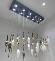 Modern chandelier with hanging glass shades in a room setting