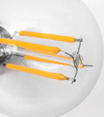 Close-up of a LED light bulb with orange filaments on a white background