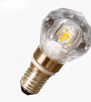 Clear glass LED light bulb with gold base on a white background