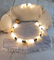Decorative pillow with string lights on a textured surface