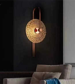Decorative wall light fixture on a dark wall with a sofa in the foreground