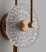 Decorative wall light fixture with crystal design and bronze finish on a neutral background