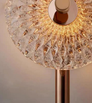 Close-up of a decorative lamp with a textured glass shade and metallic base.