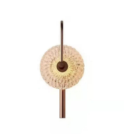 Decorative wall light fixture with a textured spherical design on a white background