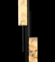 Modern wall sconce with marble-like finish on a black background