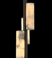 Modern wall sconce with marble-like finish on a black background