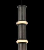 Decorative black and gold cylindrical object on a white background