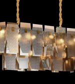 Modern chandelier with metallic finish on a black background