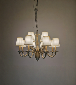 Vintage-style chandelier with six lampshades on a plain background