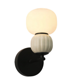 Wall-mounted light fixture with a black base, white middle section, and beige top on a white background