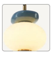 Decorative wall light fixture with a white glass shade and gold accents.