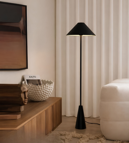 Modern living room with a black floor lamp, wooden console table, and white curtains.