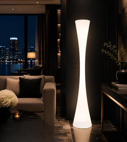 Tall floor lamp in a dimly lit living room with cityscape view
