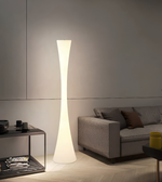 Modern floor lamp in a living room setting with a sofa and coffee table.