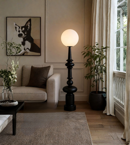 Living room with a black floor lamp, beige sofa, and decorative elements.