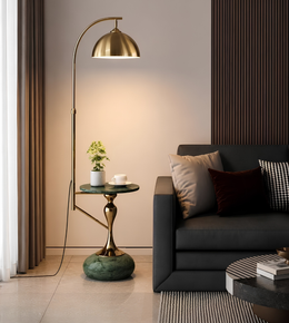 Modern living room with a gold floor lamp, black sofa, and side table.