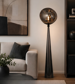 Modern living room with a floor lamp, sofa, and decorative items.