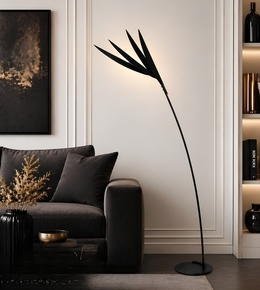 Modern living room with a black floor lamp, gray sofa, and decorative items.
