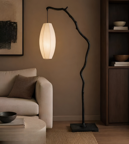 Modern floor lamp with a natural branch design in a living room setting.