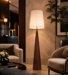 Tall floor lamp in a stylish living room setting with decor elements.
