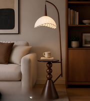 Modern living room with a floor lamp, sofa, and bookshelf.