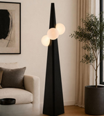 Modern black floor lamp with spherical lights in a living room setting.