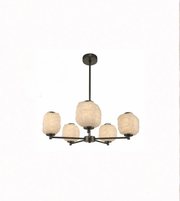 Modern chandelier with five round glass shades on a white background