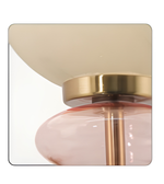 Decorative wall sconce with gold and pink design on a white background