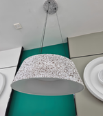 Modern pendant light fixture hanging from a ceiling with a minimalistic design.