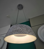 Pendant light with textured shade on a ceiling