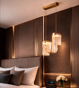 Modern bedroom with a stylish headboard, pendant lights, and decorative elements.