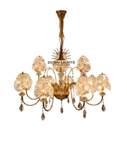 Gold chandelier with crystal accents on a white background, featuring the 'Dubai Lights' brand.