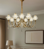 Luxurious chandelier hanging in a room with a lamp and framed picture on the wall.
