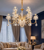 Luxurious chandelier hanging in a room with a sofa and lamp.