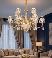 Luxurious chandelier hanging in a room with a sofa and lamp.