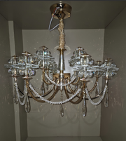 Crystal chandelier hanging from a ceiling in a room with white walls.