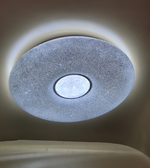 Ceiling light fixture with textured surface and central circular design