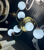 Ceiling light fixture with gold and bronze finish on a dark surface