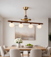 Modern dining room with a ceiling light fixture, table, chairs, and decor.