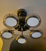 Modern ceiling light fixture with five round lights on a neutral background