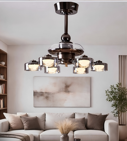Modern chandelier in a living room setting with a sofa and artwork on the wall.