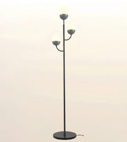 A modern three-light floor lamp with a slim black metal stand, circular base, and three spherical frosted glass shades on curved arms, shown against a plain light beige background.