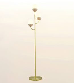 A modern floor lamp with a slim gold-finished metal stand, three curved arms, and three frosted white globe shades, shown against a plain light background.