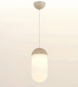 A modern pendant light with a frosted cylindrical shade and a matte beige cap and ceiling mount, shown against a plain off-white background.
